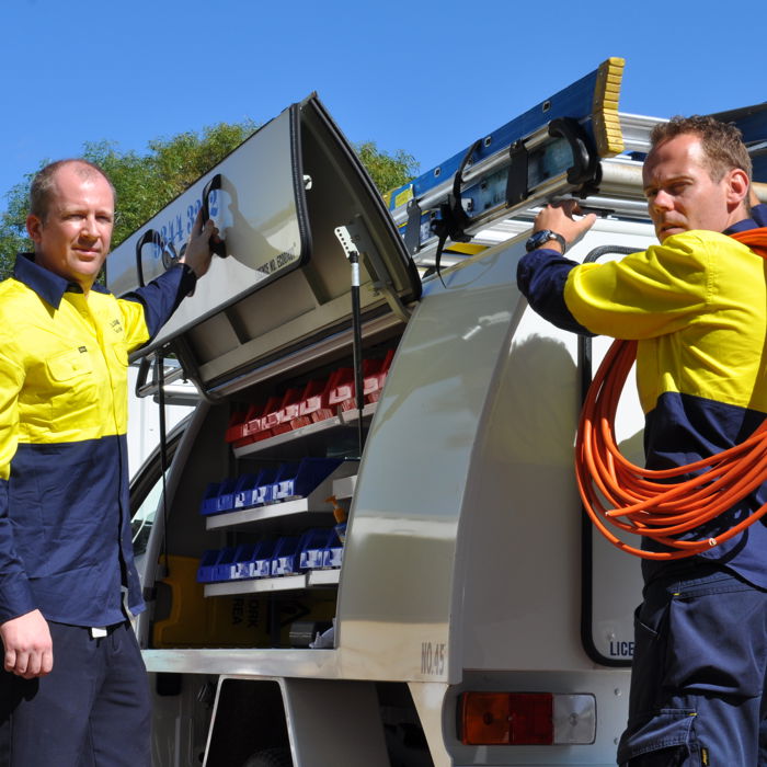 Electricians loading tools at a service ute during CET electrical contractor training in WA.